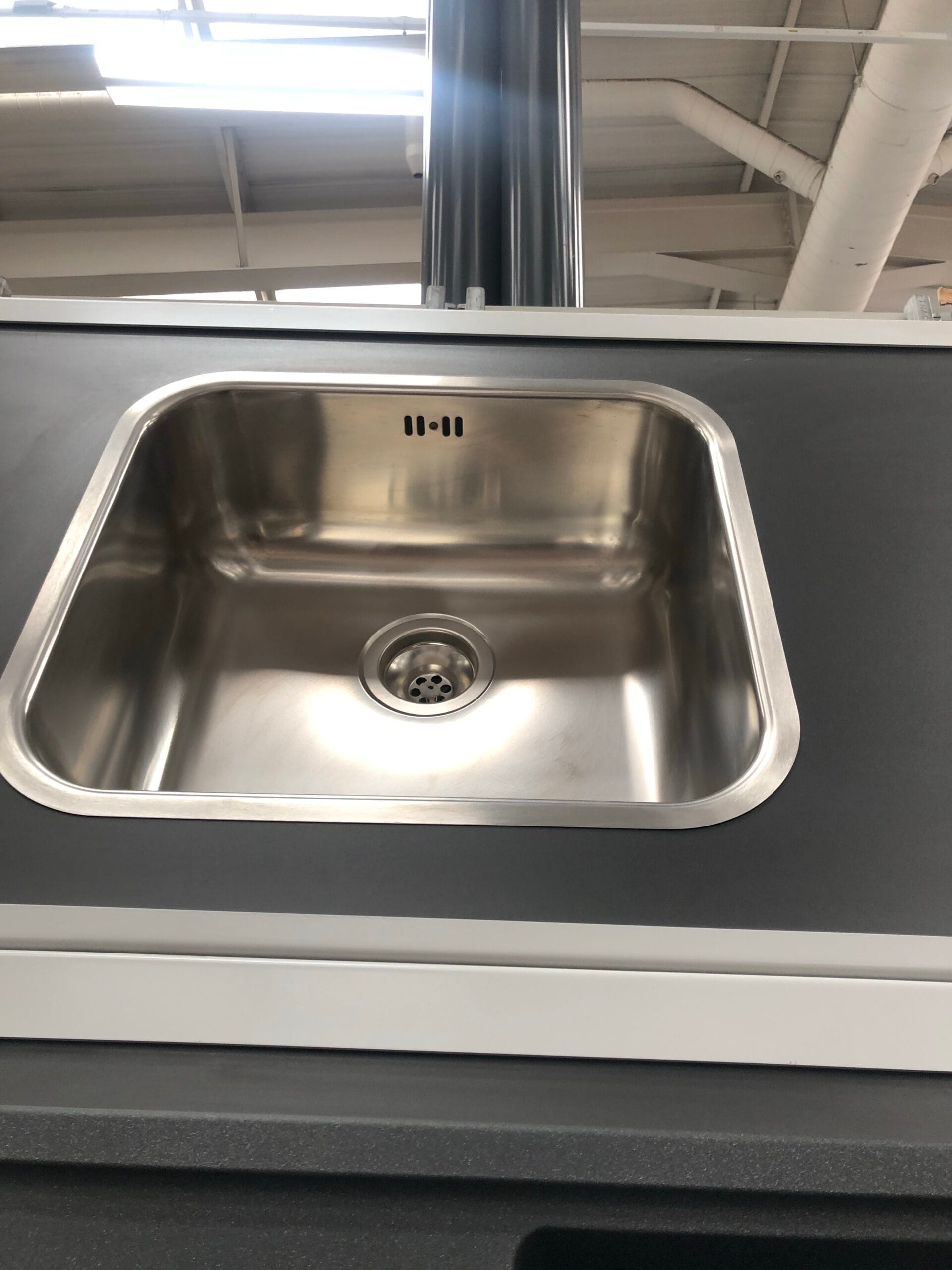 Stainless-steel kitchen sink after unblocking in London